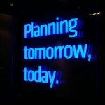 a neon sign that says planning tomorrow, today